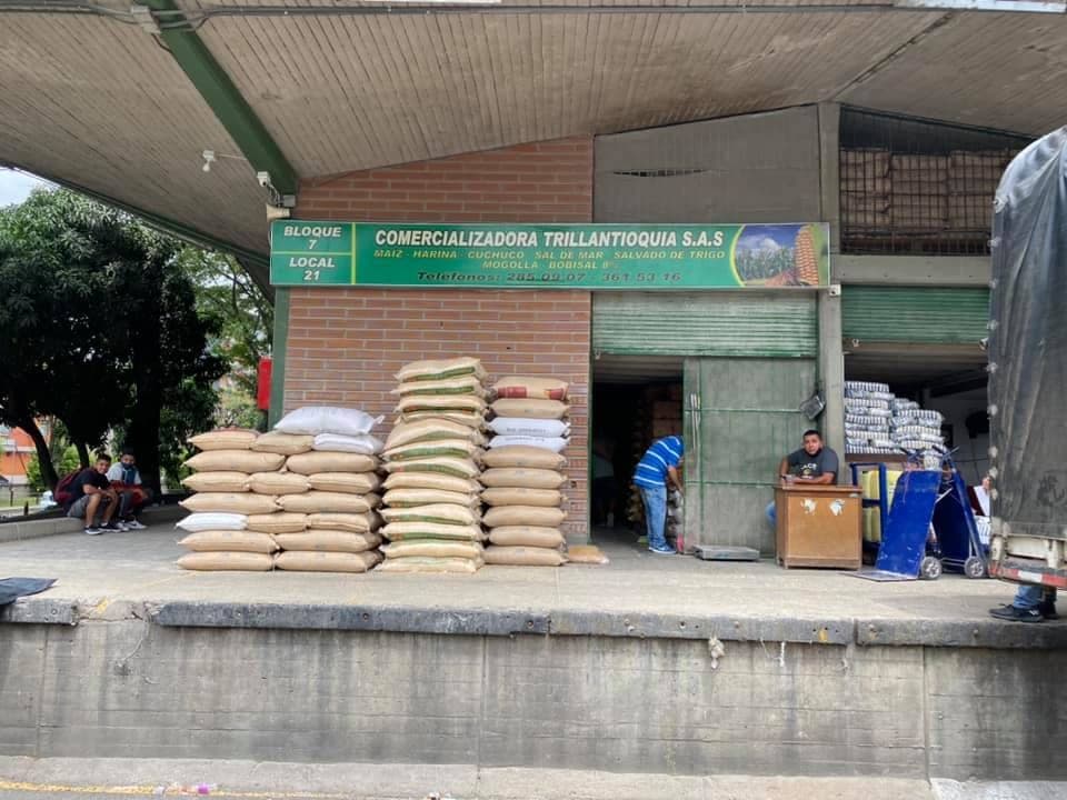 Fachada de Comercializadora Trillantioquia S.A.S. en el Bloque 7, Local 21, con bultos apilados